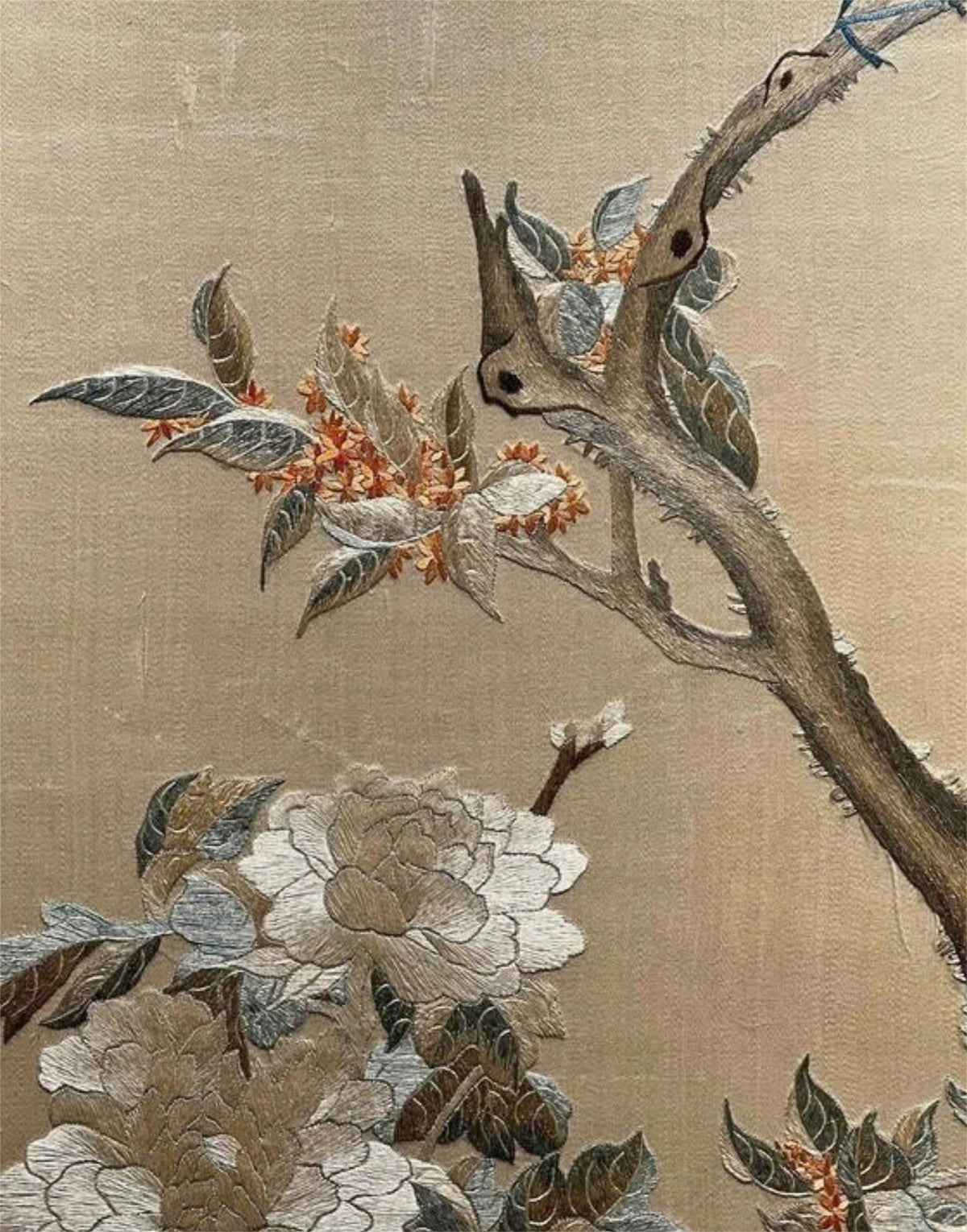 Hand-embroidered floral and bird motif on a natural textile ground
